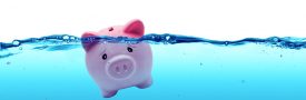 Piggy bank drowning in debt – savings to risk